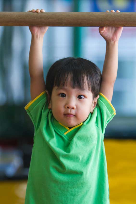 Kid holding onto the bar