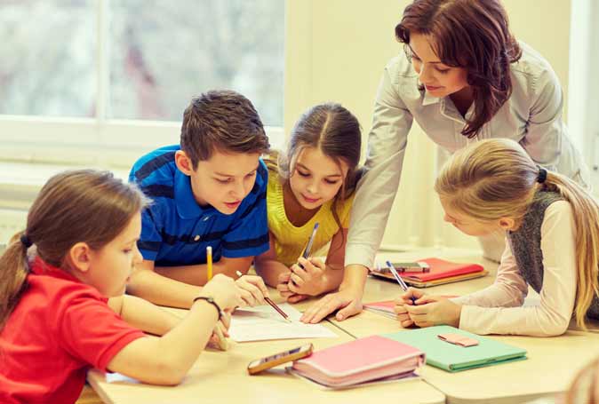 children around the table doing homework